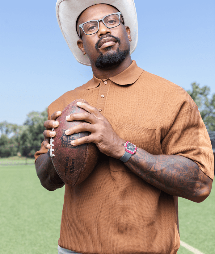 Von Miller with tattoos, watch, hat and glasses
