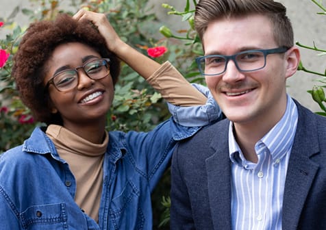 Couple wearing prescription eyeglasses from the GlassesUSA collection