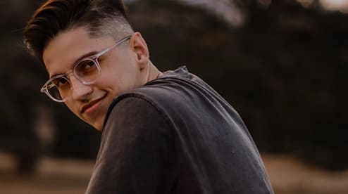 Man wearing prescription glasses from GlassesUSA eyewear collection, up to 50% off retail eyewear prices online