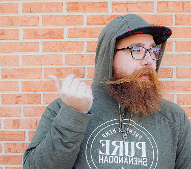 Man wearing trendy prescription glasses from GlassesUSA, up to 50% off retail eyewear prices