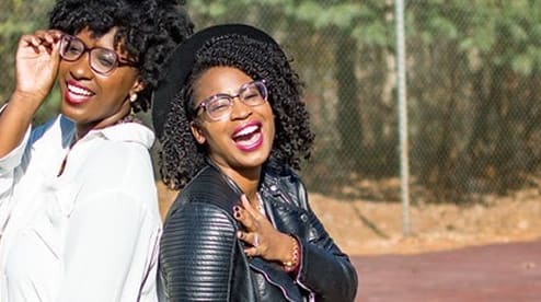 Two womens wearing different eyeglass styles from GlassesUSA online collection, affordable frames