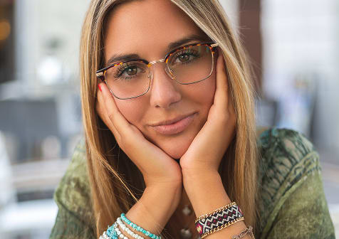 Woman wearing prescription eyeglasses from GlassesUSA, stylish frames with free shipping and returns