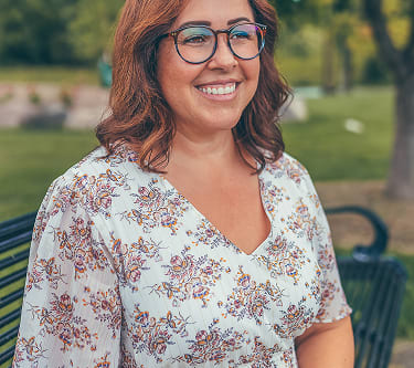 Woman wearing prescription eyeglasses from GlassesUSA, affordable frames online