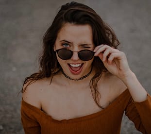 Woman wearing sunglasses from GlassesUSA online retailer, discounted eyewear with free shipping