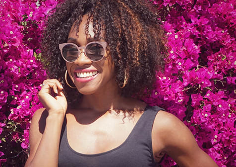 Woman wearing fashionable sunglasses from GlassesUSA eyewear collection, affordable online eyewear retailer