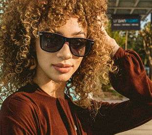 Woman wearing sunglasses from GlassesUSA affordable eyewear collection