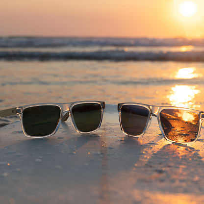 O’Neill x GlassesUSA.com Harwood 2.0 clear frame polarized sunglasses with dark green and deep blue lenses.