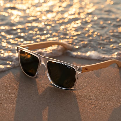 O’Neill x GlassesUSA.com Harwood 2.0 clear frame sunglasses with dark green polarized lenses and bamboo temples.