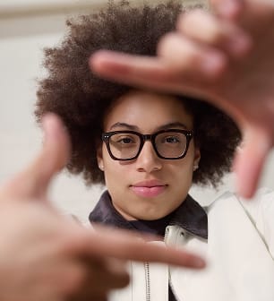 Olivia Miles reaching toward the camera