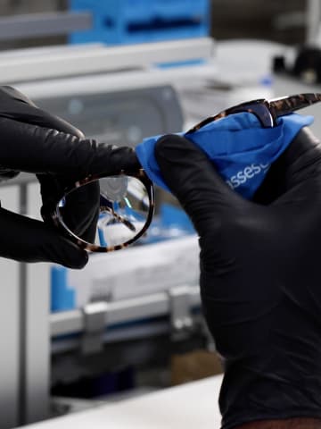 Gloved hands assembling high-quality eyeglasses