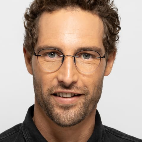Man in minimalist clear Unica glasses