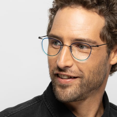 Man wearing custom blue Unica glasses